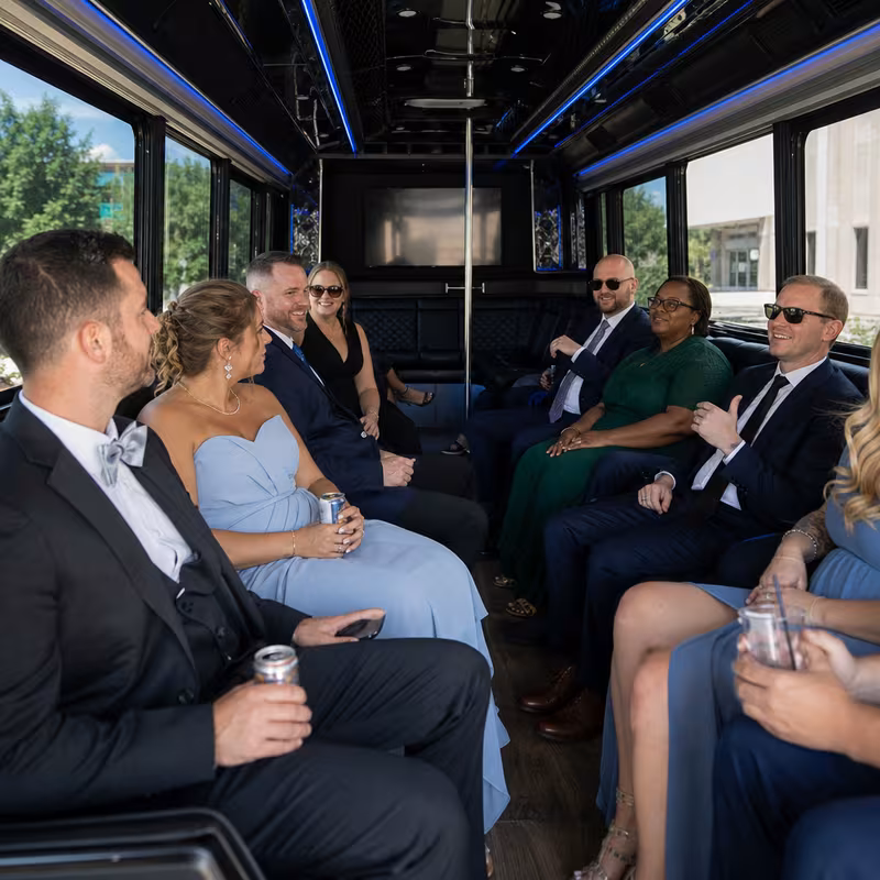 Wedding guests seated inside a Peoria party bus