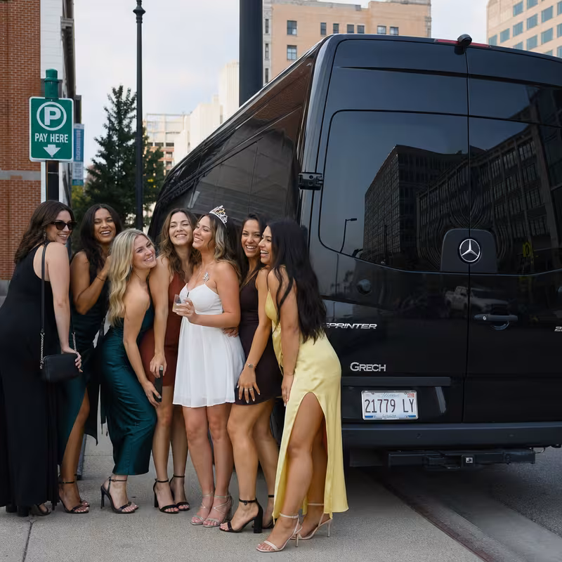 Group boarding a white charter bus for Bachelor & Bachelorette Transportation transportation in Peoria