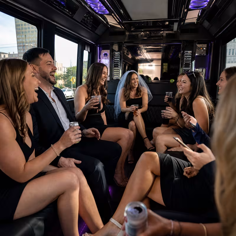 Party bus interior with wraparound leather seating and LED lighting in Peoria