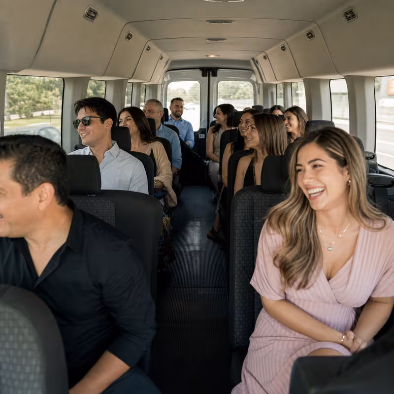 Group boarding a white charter bus for Private Event Transportation transportation in Peoria