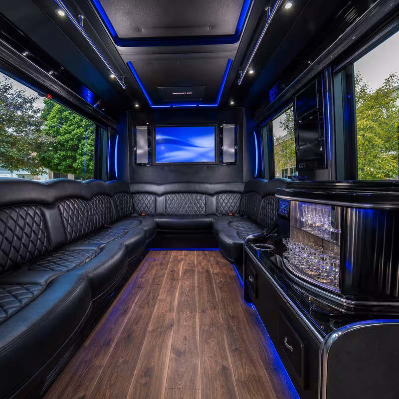 Party bus interior with wraparound leather seating and LED lighting in Peoria