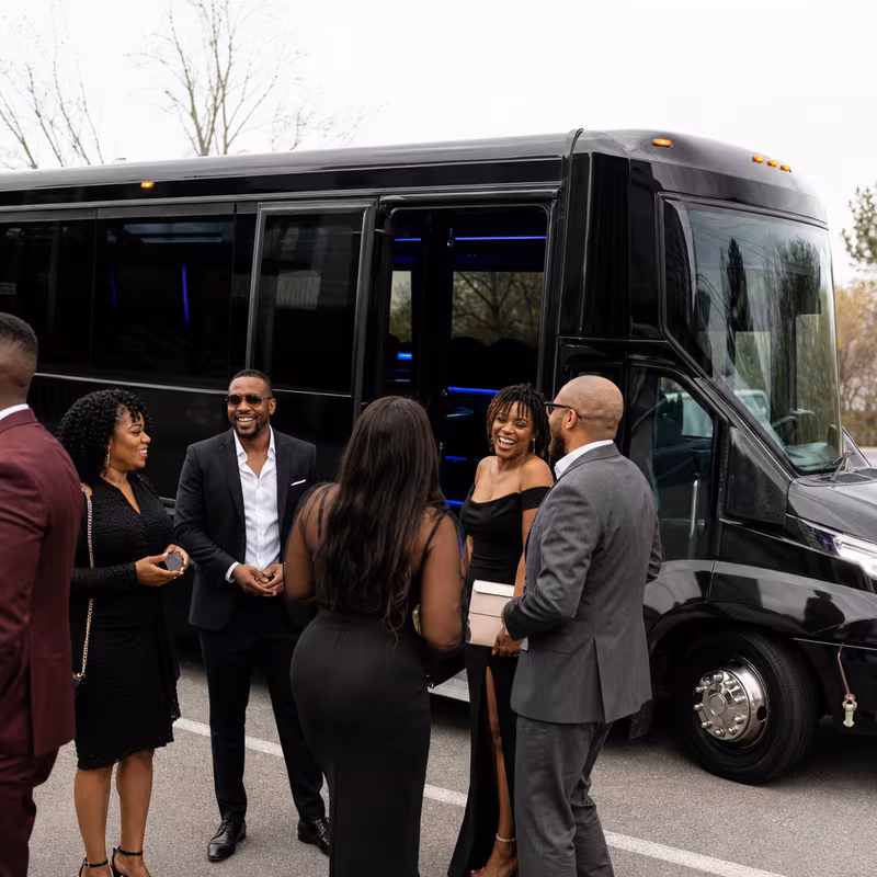 Passengers loading luggage while boarding an Peoria group shuttle