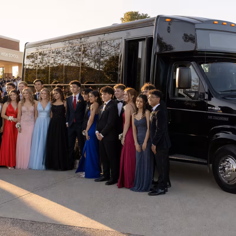 Group boarding a white charter bus for Prom & Homecoming Transportation transportation in Peoria