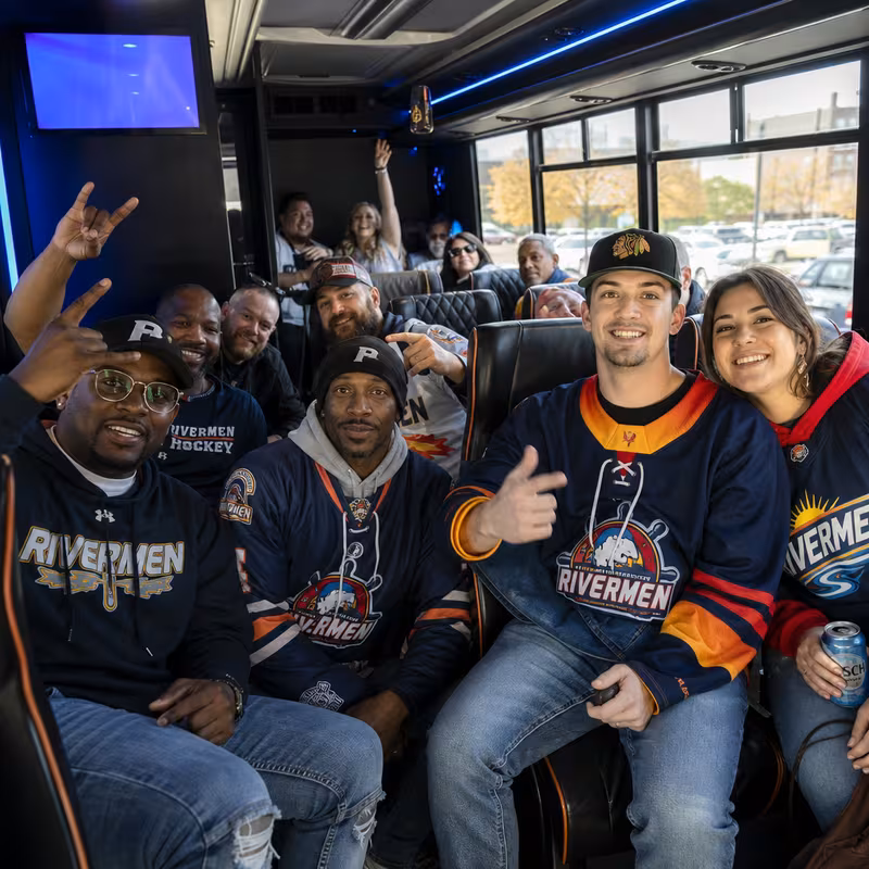 Group boarding a white charter bus for Sporting Event Transportation transportation in Peoria