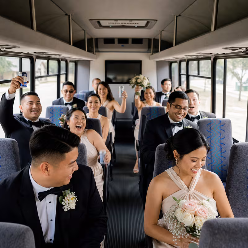 Group boarding a white charter bus for Wedding Transportation transportation in Peoria