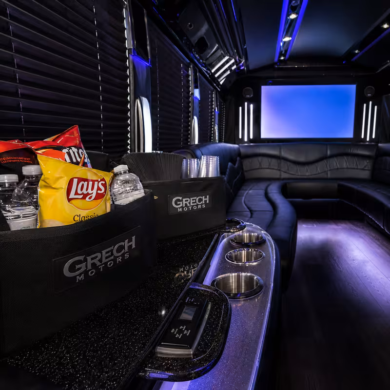 Party bus interior with wraparound leather seating and LED lighting in Peoria